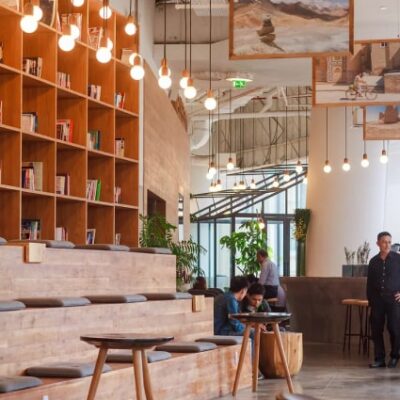 The interior of a coffee shop with a lot of bookshelves.