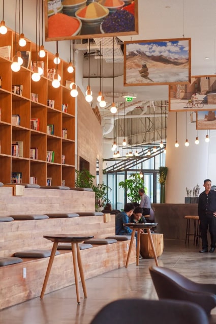 The interior of a coffee shop with a lot of bookshelves.