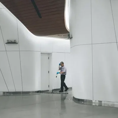 A person is standing in a hallway.