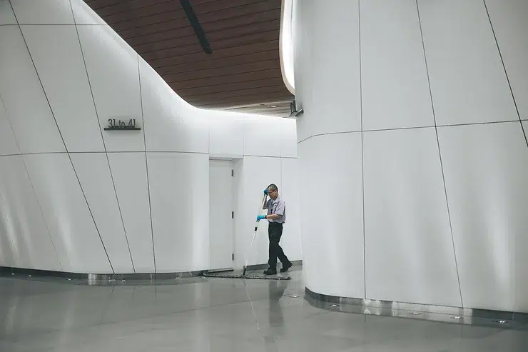 A person is standing in a hallway.