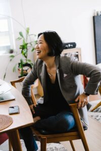 Happy woman smiling in a brightly lit, clean office environment